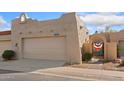 Exterior view of a one-story home with a two car garage, gate, and desert landscaping at 16648 N 30Th Ave, Phoenix, AZ 85053