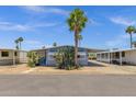 Inviting single-story residence with covered carport, accented by palm trees and desert landscaping at 2650 W Union Hills Dr # 215, Phoenix, AZ 85027