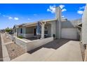 Single-story home with attached garage and front porch with desert-friendly landscaping and patio at 2929 E Broadway Rd # 50, Mesa, AZ 85204
