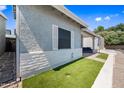 A side yard with some artificial turf and a charming white brick wall and gate at 2929 E Broadway Rd # 50, Mesa, AZ 85204
