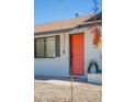 Close-up of a vibrant orange front door with modern accents and desert-friendly landscaping at 3325 S Shafer Dr, Tempe, AZ 85282