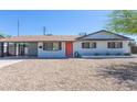 Inviting single-story home with a colorful front door, desert landscaping, and a convenient carport at 3325 S Shafer Dr, Tempe, AZ 85282