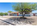 Single-story home with gravel front yard, shaded by a mature tree, and a carport at 3325 S Shafer Dr, Tempe, AZ 85282