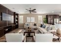 Comfortable living room features built-in shelving, ceiling fan and two sofas with throw pillows at 3338 E Coconino Dr, Gilbert, AZ 85298
