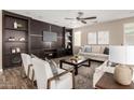 Cozy living room showcases built-in shelving, ceiling fan and two sofas with decorative pillows at 3338 E Coconino Dr, Gilbert, AZ 85298
