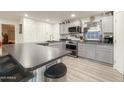 Modern kitchen boasts stainless steel appliances, gray cabinets, and a sleek breakfast bar at 3515 E Kings Ave, Phoenix, AZ 85032