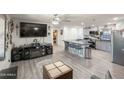 Open-concept living room and kitchen offers a breakfast bar and contemporary decor at 3515 E Kings Ave, Phoenix, AZ 85032