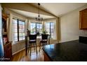 Bright breakfast nook featuring hardwood floors, pendant lighting, and lots of natural light at 4527 E Amberwood Dr, Phoenix, AZ 85048