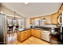 Bright kitchen featuring granite countertops, stainless steel appliances, and wood cabinets at 4527 E Amberwood Dr, Phoenix, AZ 85048