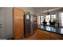 Bright kitchen featuring wood cabinets, stainless steel appliances, and a breakfast nook at 4527 E Amberwood Dr, Phoenix, AZ 85048