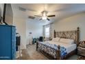 Comfortable main bedroom featuring a ceiling fan, carpeted floors and a metal bed frame at 5267 E Diatomite Dr, San Tan Valley, AZ 85143