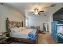 Comfortable main bedroom featuring a ceiling fan, carpeted floors and a metal bed frame at 5267 E Diatomite Dr, San Tan Valley, AZ 85143