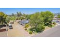 This home offers a long driveway, mature trees, and a well-maintained lawn at 6330 E Delcoa Ave, Scottsdale, AZ 85254