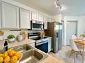 Efficient kitchen includes stainless steel appliances, light cabinetry, and stylish tiled flooring at 7801 N 44Th Dr # 1180, Glendale, AZ 85301