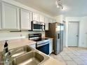 Well-equipped kitchen featuring stainless steel appliances, bright cabinets, and modern tile floor at 7801 N 44Th Dr # 1180, Glendale, AZ 85301