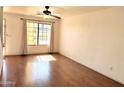 Bright living room boasts hardwood floors, ample natural light, ceiling fan, and neutral walls at 7801 N 44Th Dr # 1180, Glendale, AZ 85301