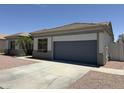 A single-story home featuring a gray 2 car garage and desert landscaping at 81 E Smoke Tree Rd, Gilbert, AZ 85296