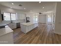 A bright, open kitchen featuring a large island, white cabinets, and stainless steel appliances at 81 E Smoke Tree Rd, Gilbert, AZ 85296