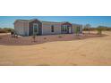 Charming single-Gathering home with rock landscaping and a walkway leading to the front door at 873 N Windy Meadow Ln, Maricopa, AZ 85139