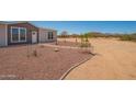 Charming single-Gathering home with rock landscaping and a walkway leading to the front door at 873 N Windy Meadow Ln, Maricopa, AZ 85139