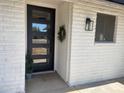 Charming front porch with a modern multi-paneled front door and decorative wreath at 9053 N 53Rd Ave, Glendale, AZ 85302
