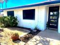 Inviting front exterior with desert landscaping and a black modern front door at 9053 N 53Rd Ave, Glendale, AZ 85302