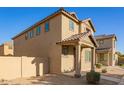 Well-maintained two-story home with desert landscaping and covered porch at 909 E Agua Fria Ln, Avondale, AZ 85323