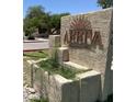 Stone Arriva Condominiums sign featuring the community name and artistic sun design, framed by lush greenery at 1340 N Recker Rd # 154, Mesa, AZ 85205