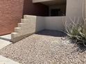 Outdoor patio featuring decorative rock landscaping adjacent to the building at 1340 N Recker Rd # 154, Mesa, AZ 85205