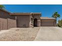Beige single-story home featuring desert landscaping and a two-car garage at 162 W Raven Dr, Chandler, AZ 85286