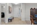 A welcoming entryway with tiled floors, neutral walls, and a bench, leading to a bright white door at 1673 E Laddoos Ave, Queen Creek, AZ 85140