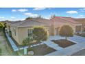 Charming single-story home with a tile roof, landscaped front yard, and walkway leading to the entrance at 1673 E Laddoos Ave, Queen Creek, AZ 85140