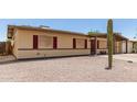 Cozy single-level home featuring red-trimmed windows and xeriscaping in the front yard for water conservation at 18217 N 34Th Ave, Phoenix, AZ 85053