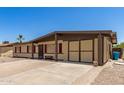Inviting single-level home showcasing a covered carport and cozy front bench, enhancing its welcoming charm at 18217 N 34Th Ave, Phoenix, AZ 85053