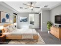 Spacious main bedroom with ensuite bathroom access, neutral walls, and a ceiling fan at 18389 W Long Lake Rd, Goodyear, AZ 85338