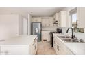 Bright kitchen boasts new appliances, white cabinets, and a modern sink with stylish fixtures at 201 S 91St St, Mesa, AZ 85208