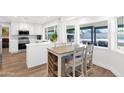 Bright kitchen featuring white cabinetry, stainless steel appliances, and large windows overlooking the backyard at 2607 E Mercer Ln, Phoenix, AZ 85028