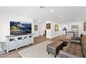 Spacious living room with modern decor, wood flooring, and ample natural light at 2607 E Mercer Ln, Phoenix, AZ 85028