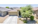Single-story home with a two-car garage, stone accents, and desert landscaping at 2717 W Bowker St, Phoenix, AZ 85041