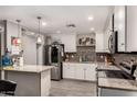 Kitchen featuring stainless steel appliances, granite countertops, and wooden floors at 2749 W San Juan Ave, Phoenix, AZ 85017
