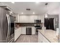 Well-lit kitchen with stainless steel appliances and stylish backsplash at 2749 W San Juan Ave, Phoenix, AZ 85017