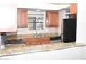 Kitchen features stone countertops, a pass-through, and stainless steel appliances at 3420 W Danbury Dr # C130, Phoenix, AZ 85053