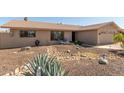 Single-story home with desert landscaping and a cozy outdoor seating area on the front porch at 3529 W Saint Moritz Ln, Phoenix, AZ 85053