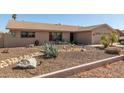 Single-story home featuring desert landscaping with natural rocks and desert plants at 3529 W Saint Moritz Ln, Phoenix, AZ 85053