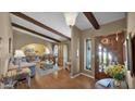 Inviting entryway with hardwood floors, decorative wood beams, and a charming stained glass window at 426 E Carol Ann Way, Phoenix, AZ 85022
