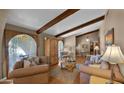 Cozy living room featuring hardwood floors, exposed wood beams, and ample natural light at 426 E Carol Ann Way, Phoenix, AZ 85022