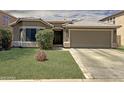 Beautiful single-story home with lush green lawn, desert landscaping, and a convenient two-car garage at 45726 W Long Way, Maricopa, AZ 85139