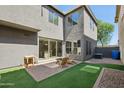 A private backyard featuring synthetic grass, a paved patio and low maintenance desert landscaping at 4712 E Bonanza Rd, Gilbert, AZ 85297