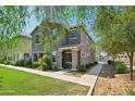 Charming two-story home with mature shade trees and desert landscaping for curb appeal at 4712 E Bonanza Rd, Gilbert, AZ 85297