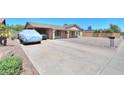 A wide driveway leads up to this single-story home with a covered carport at 5800 S College Ave, Tempe, AZ 85283